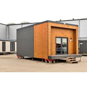 Modern portable cabin with wooden cladding and glass doors on mobile base