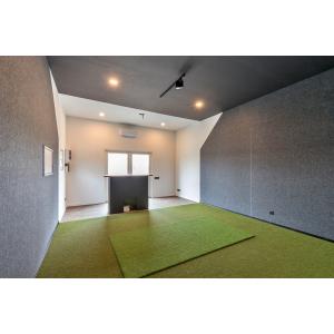 Golf simulator cabin interior with custom wooden counter and projection screen