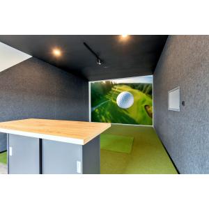 Indoor golf simulator room with artificial turf and large golf course wall graphic