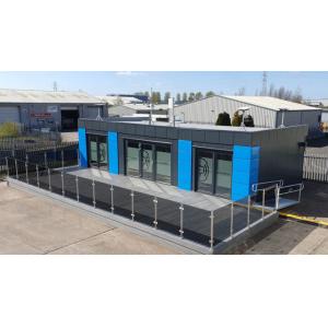 Sustainable modular commercial building featuring energy-efficient design, QuadCore insulation, and eco-friendly blue accent panels by KC Cabins Solutions