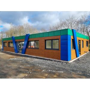 Custom modular building featuring unique multi-color design, wood cladding, and sustainable materials showcasing KC Cabins' premium bespoke solutions