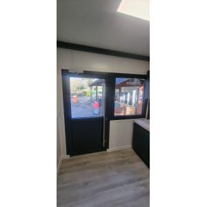 Commercial-grade split doors with safety glass panels in modular restaurant