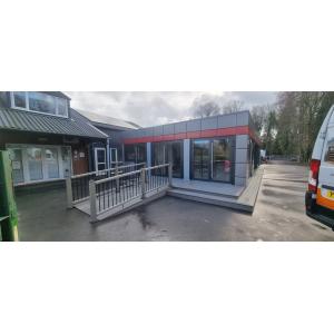 Modular restaurant entrance with accessibility ramp and glass doors