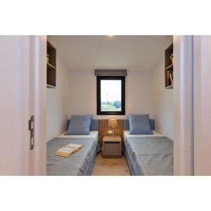 Texel Deluxe Mobile Home twin bedroom featuring built-in storage and triple-glazed window