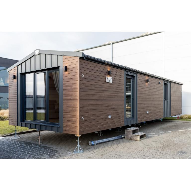 Modern luxury mobile home with brown composite cladding and anthracite grey windows