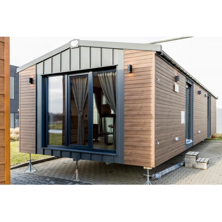 Luxury modular home exterior with triple-glazed sliding doors and dual-tone cladding design
