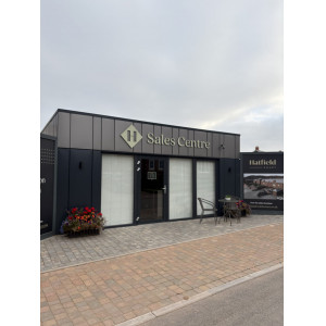 Branded portable sales centre with anthracite grey cladding, illuminated signage and integrated blinds for Hatfield Court development by KC Modular Buildings