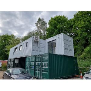 Large Z design converted shipping container UK - two 40ft containers in Z-shape configuration with white and green cladding, large windows, and modern eco-home design