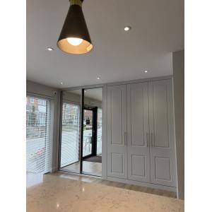 Marketing suite entrance area with floor-to-ceiling fitted wardrobes, mirrored sliding doors, designer pendant lighting and glazed patio doors by KC Modular Buildings