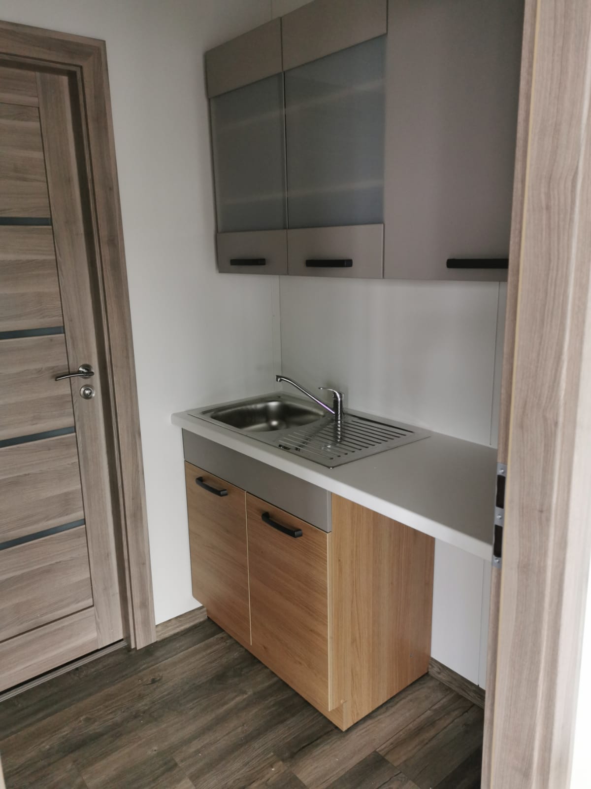 Curry bespoke modular building interior showing open-plan office layout with modern finishes, LED lighting, vinyl flooring, and insulated walls by KC Modular Buildings UK