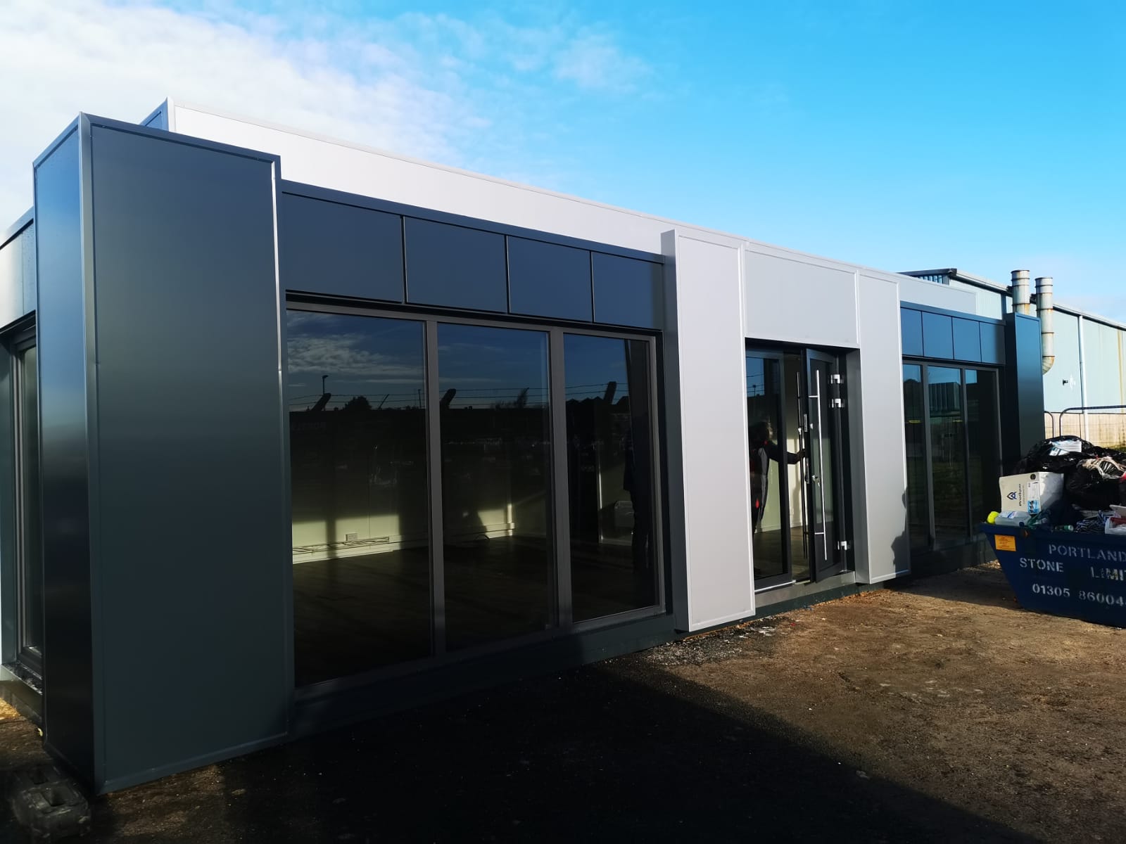 Curry bespoke modular building exterior showing 12m steel-frame construction with KINGSPAN insulated panels, precision-engineered corner angles, modern design, and large windows by KC Modular Buildings UK