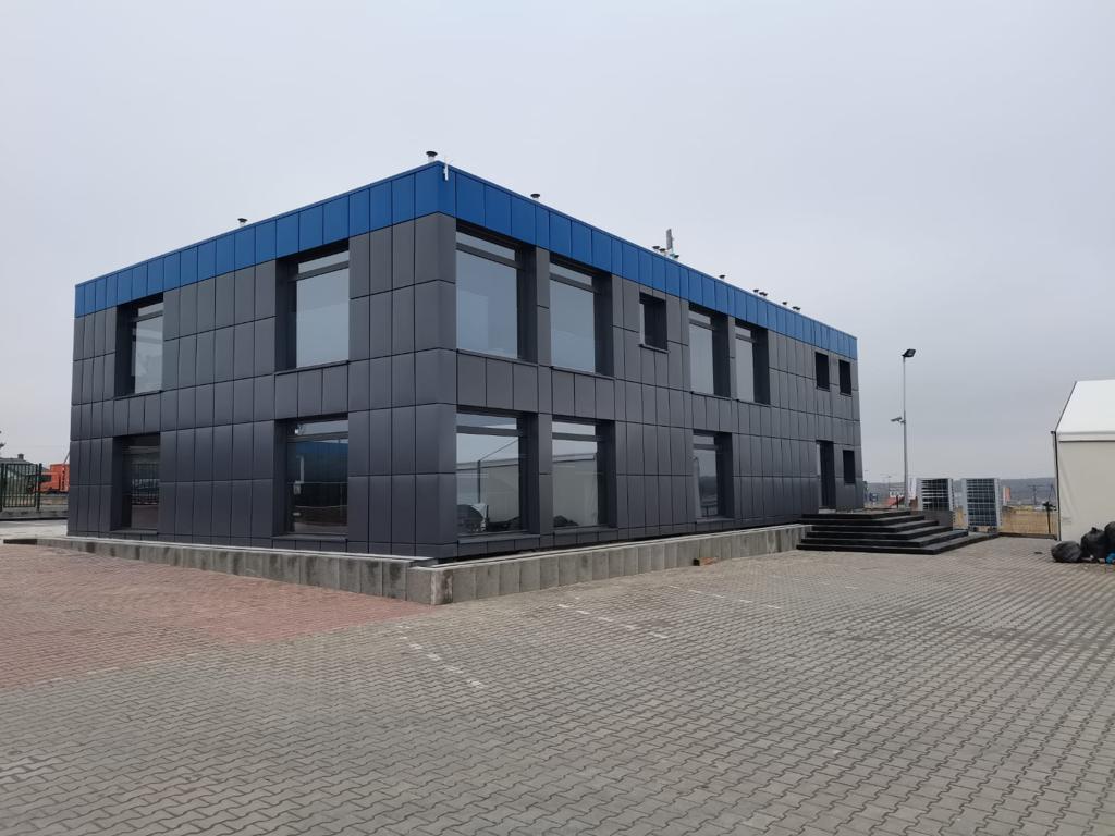 Two-storey ISO Frame modular office building with anthracite grey cladding and blue roof trim by KC Modular Buildings UK