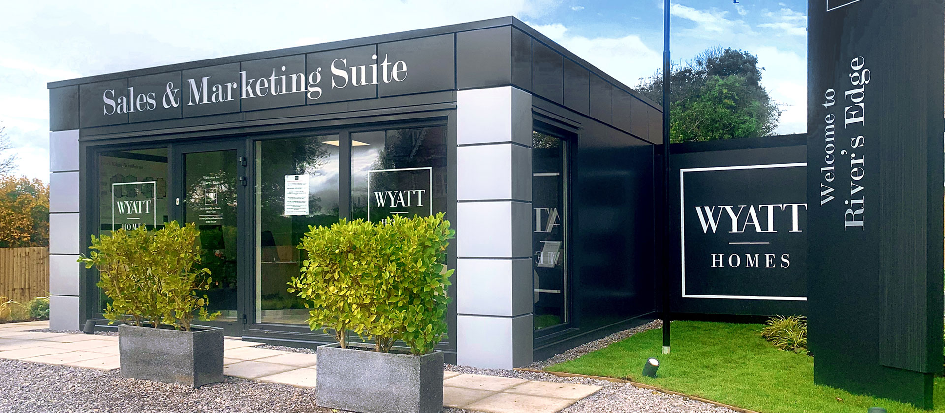 Modular office exterior with mid-range professional finish - modern cladding and aluminium windows on permanent commercial building