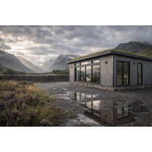 Larch-clad estate office lodge in Scottish Highlands with green sedum roof and mountain views, manufactured by KC Modular Buildings