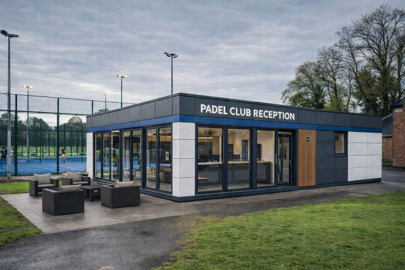 Modern modular padel clubhouse reception building with aluminium glazing and composite cladding at a UK padel facility