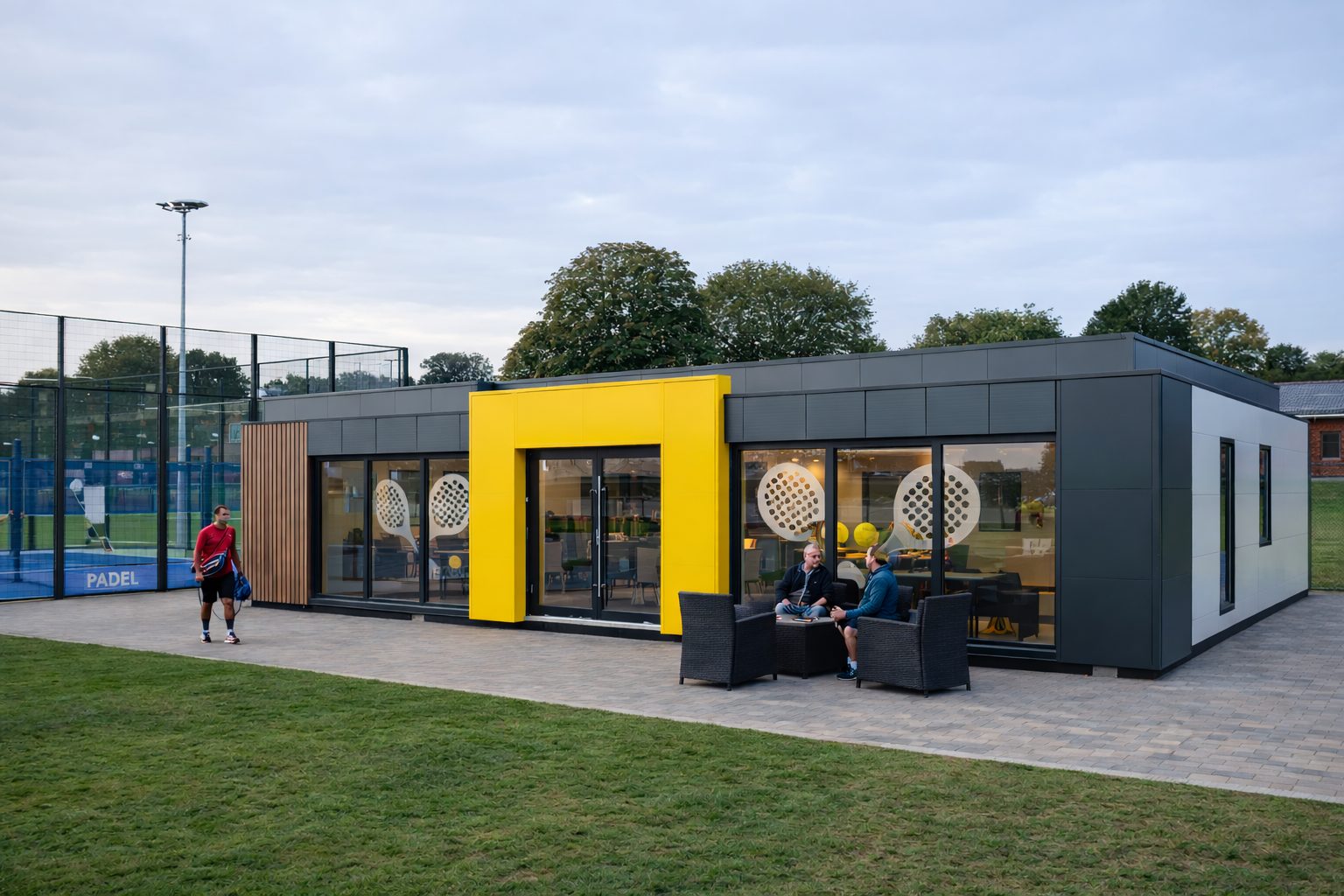 Modern modular padel clubhouse building with full-height glazing and premium cladding at a UK padel facility