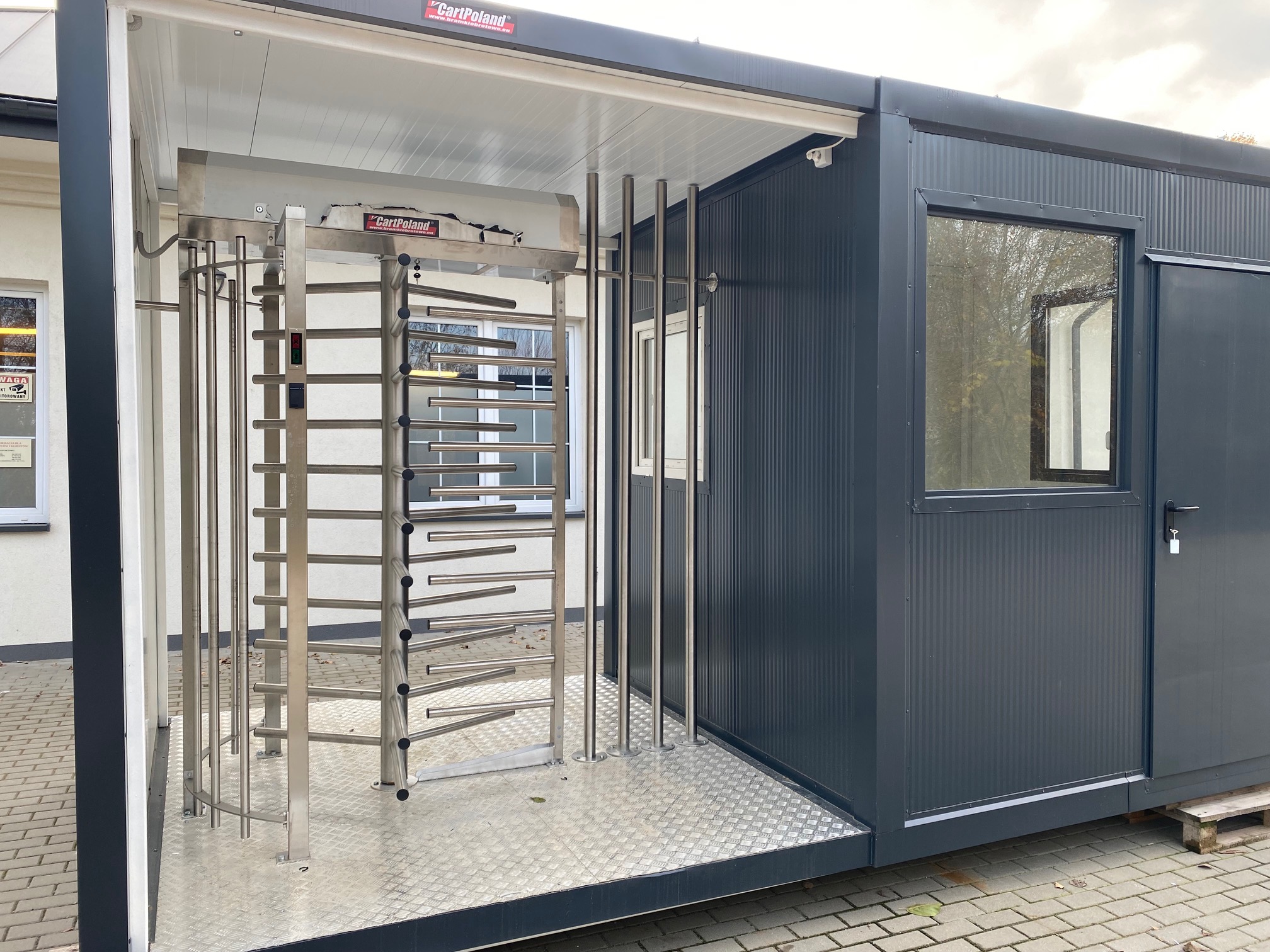 Modular gatehouse with stadium access barrier Modular gatehouse with stadium-style access barrier and pedestrian control lane