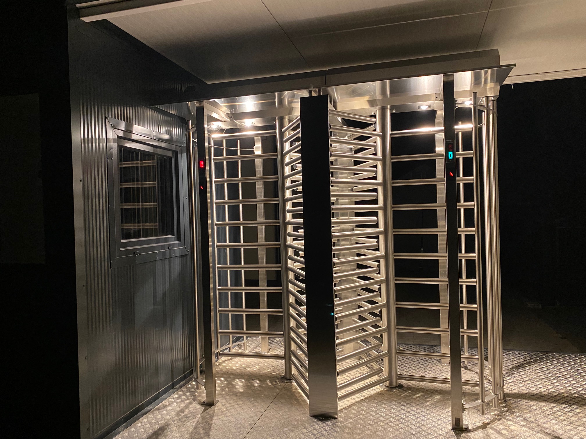 Modular security gatehouse with illuminated entry turnstiles and checkpoint control equipment