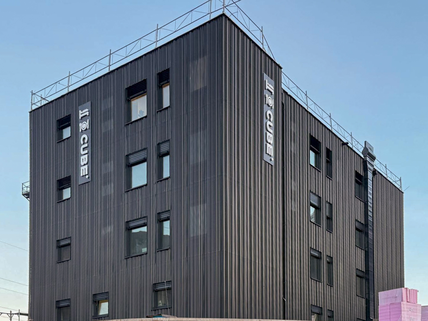 CUBE Alpine Stay exterior modular hotel accommodation block with dark cladding