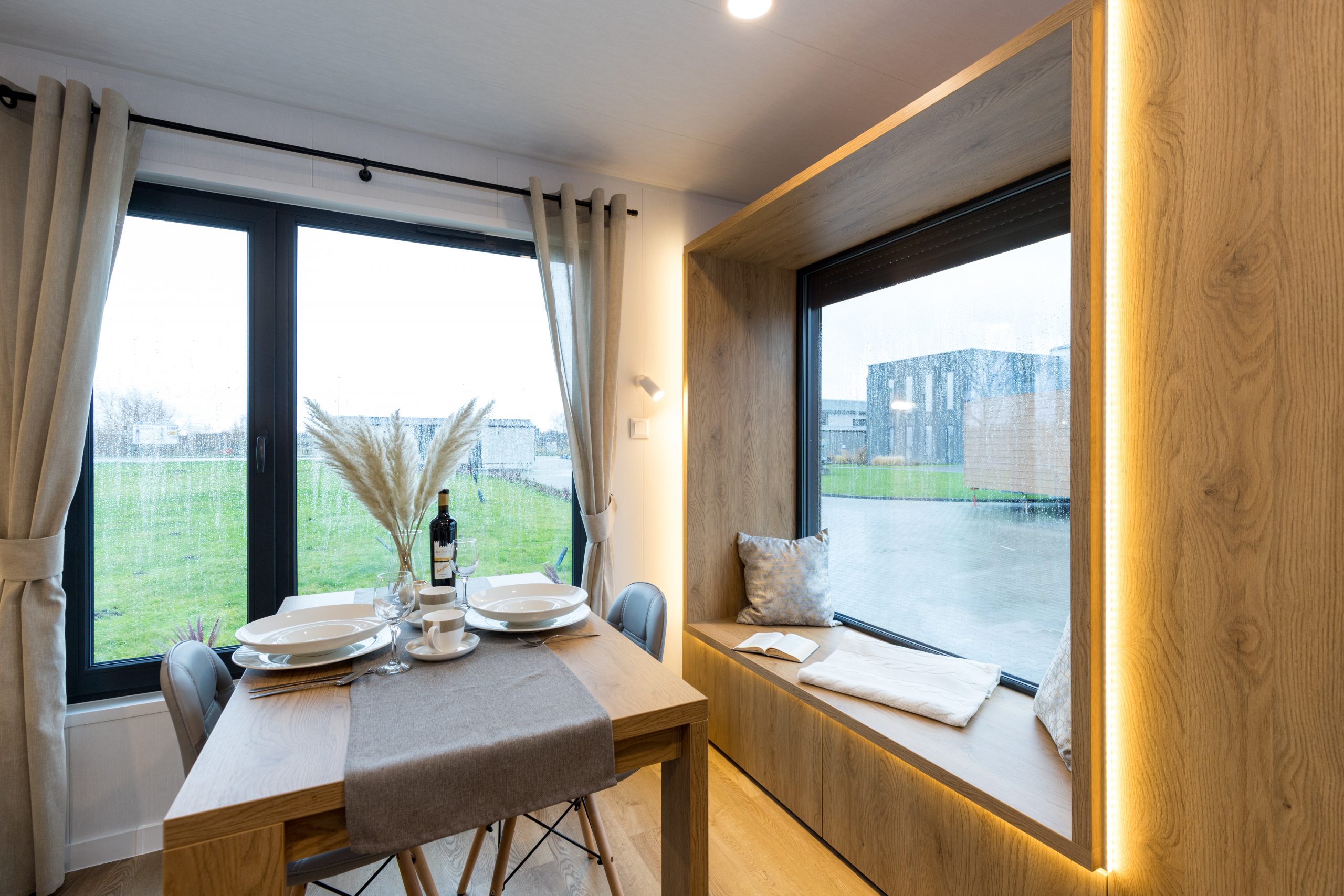 Garden pod dining and living area with modern interior lighting and furniture
