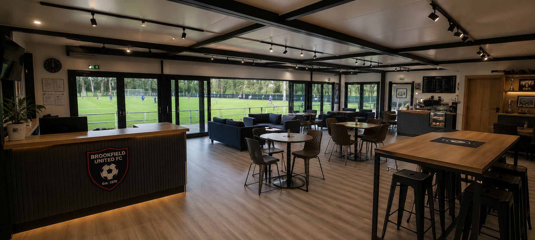 modern football club social space lounge with pitch view for match-day hospitality