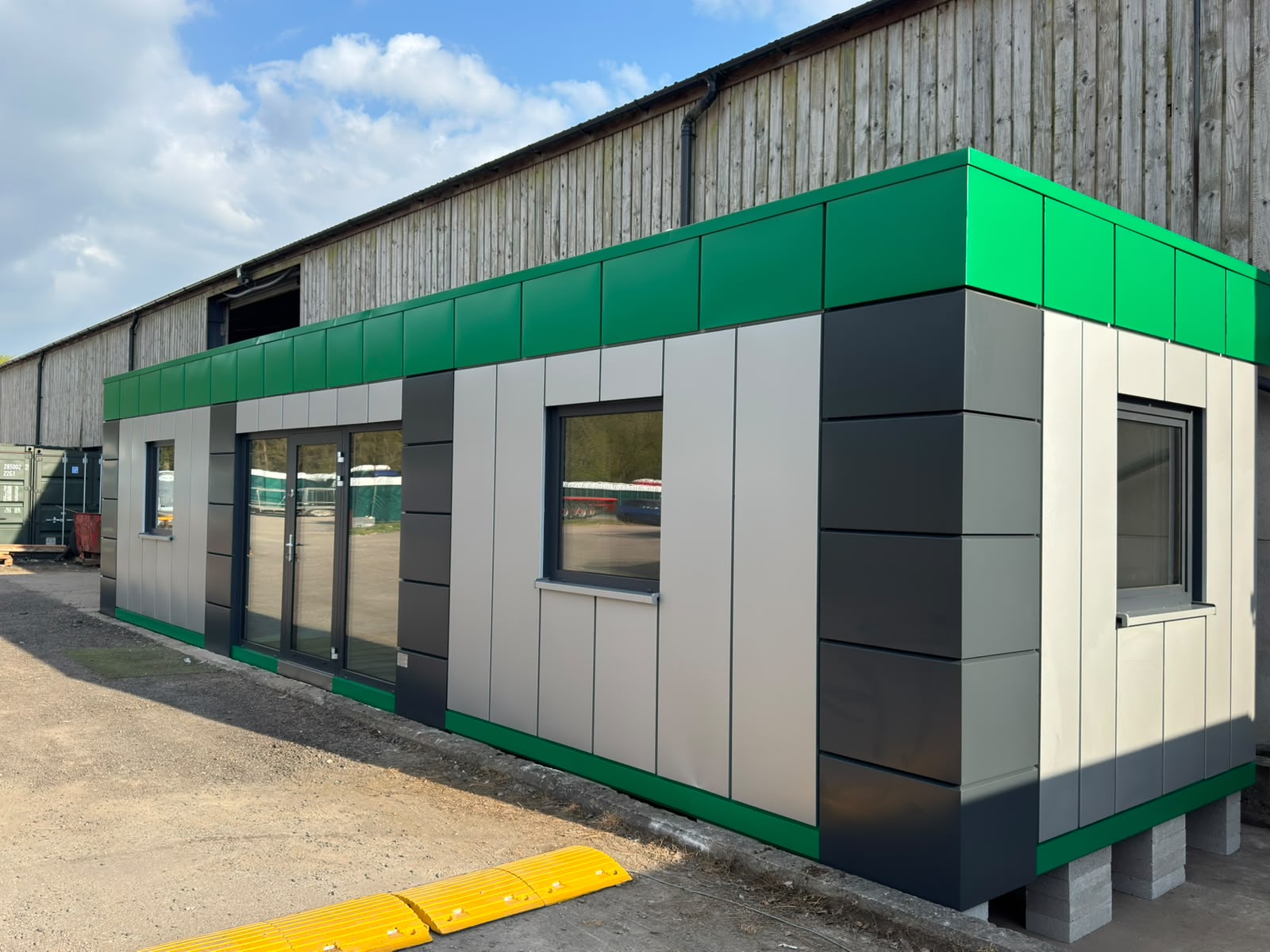 KC ventilated façade system on Excloosive Ltd modular office in green black and grey panels